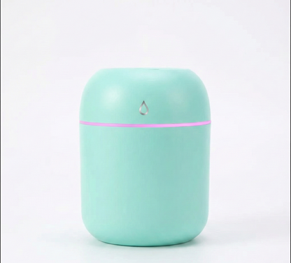 Mint green humidifier with a pink accent on a white background