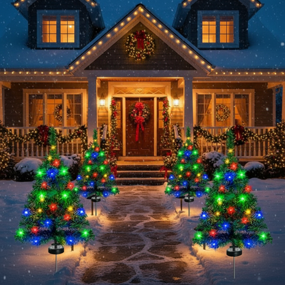 Decorative Christmas trees with lights in front of a house with &