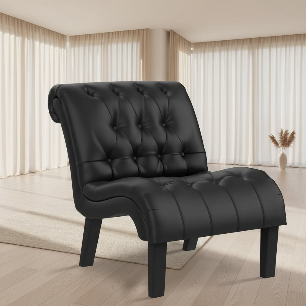 Black tufted armchair in a living room setting with a fireplace and window.