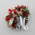 Decorative Christmas wreath with ribbons, berries, and a letter &