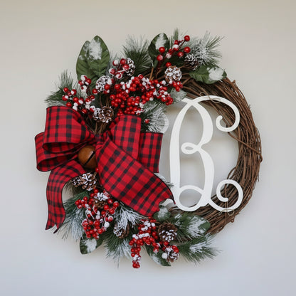 Christmas wreath with red plaid bow, berries, and monogram letter &